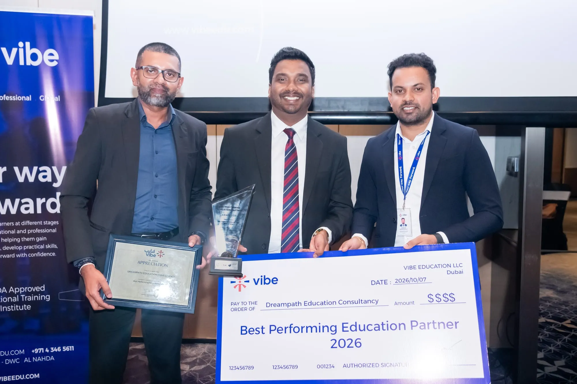 DreamPath's Best Performing Education Partner 2026 cheque, trophy and certificate, held up at the Vibe Education ceremony