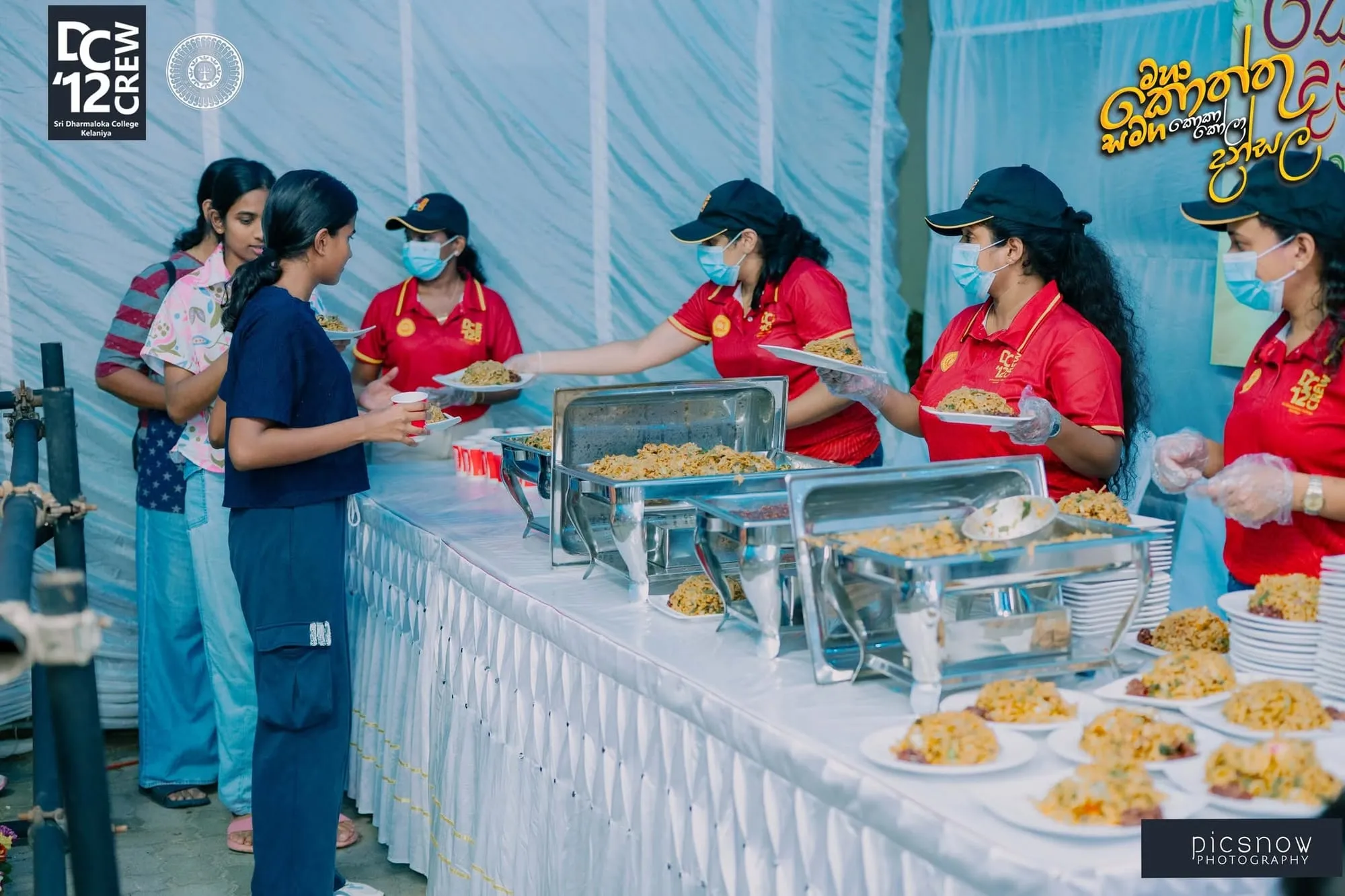 Volunteers serving kottu at the Sri Dharmaloka College Kottu Dansala, sponsored by DreamPath