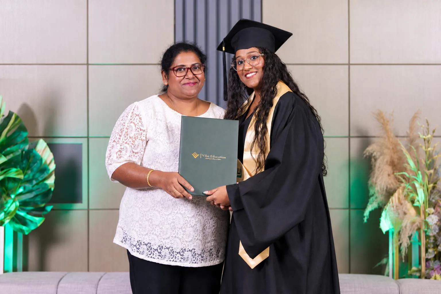Sharan Senevirathne with her mother, holding her graduation certificate